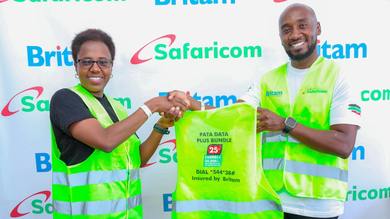 Evah Kimani(L), Director of Partnerships and Digital at Britam, is engaged by Gideon Karimi(R), Head of Mobile Data at Safaricom. PHOTO/COURTESY